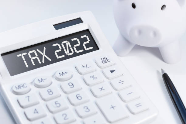 Word Tax 2022 on calculator. Business and tax concept on white background. Top view.  tax stock pictures, royalty-free photos u0026amp; images