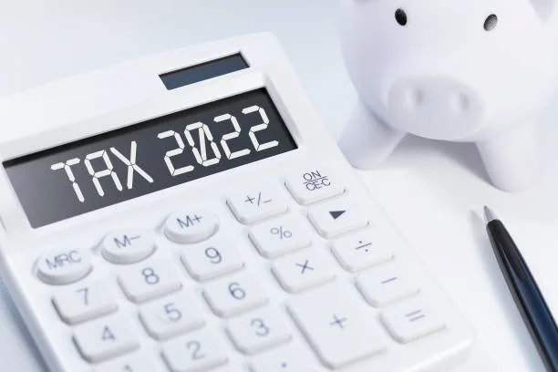 Word Tax 2022 on calculator. Business and tax concept on white background. Top view.  tax stock pictures, royalty-free photos u0026amp; images